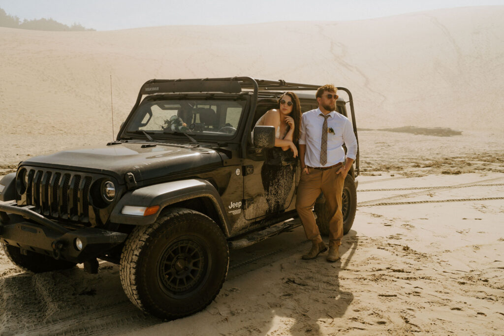 fun elopement couple with a jeep at sand dunes