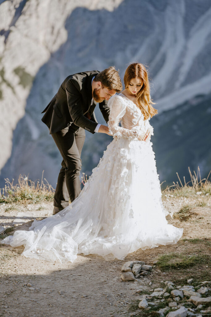 elopement couple getting ready at the mountain top during their dolomites elopement