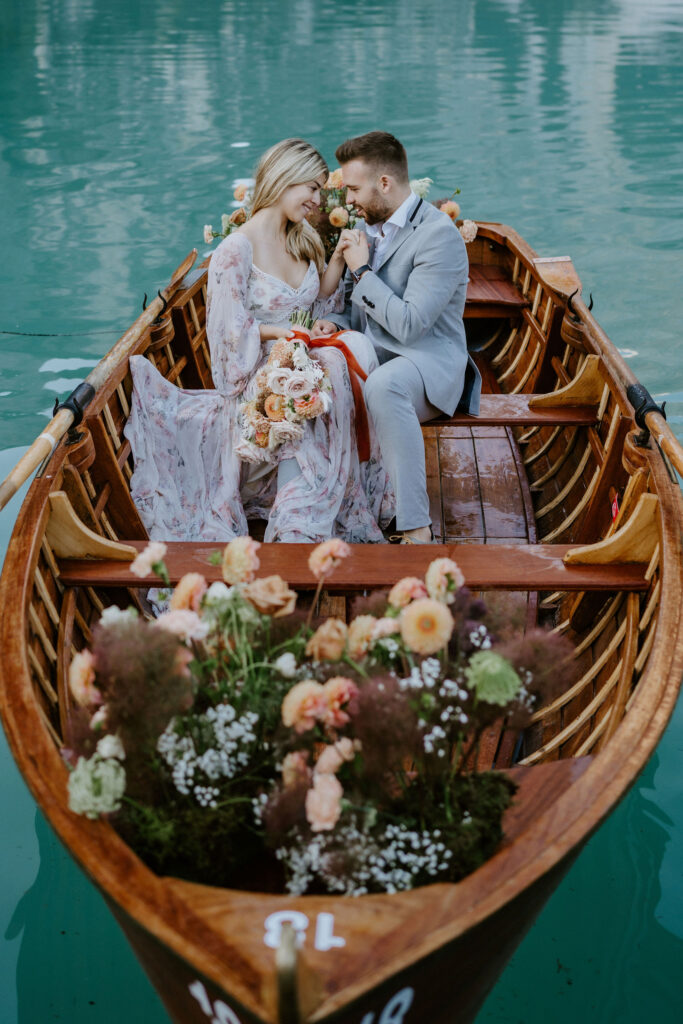 romantic elopement couple in a boat at lago di braies