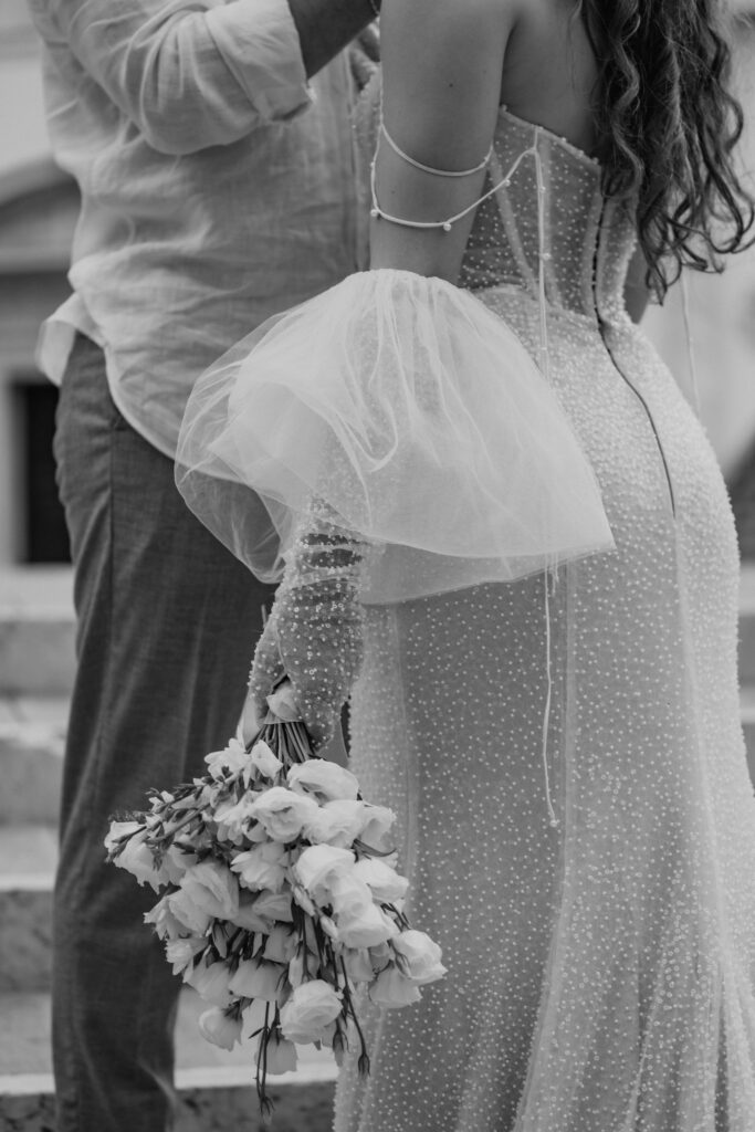 venice elopement couple on some steps with a historic building in the background
