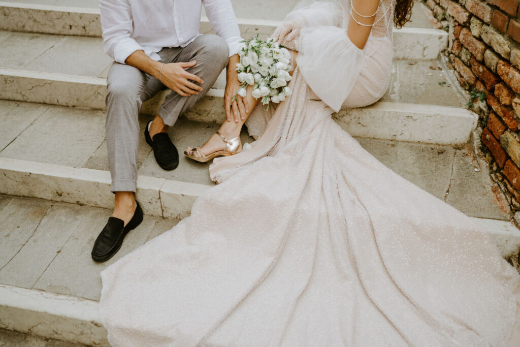 elopement couple sitting on some steps in venice