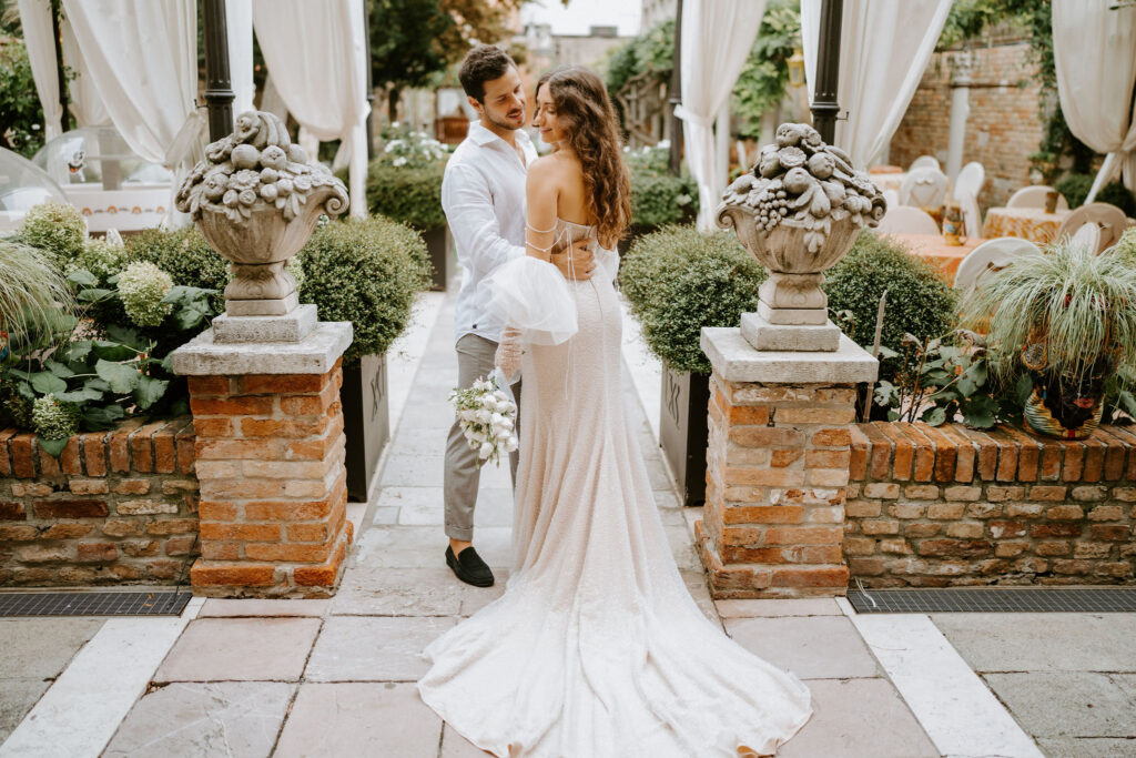 romantic elopement couple walking through a garden area during their venice elopement