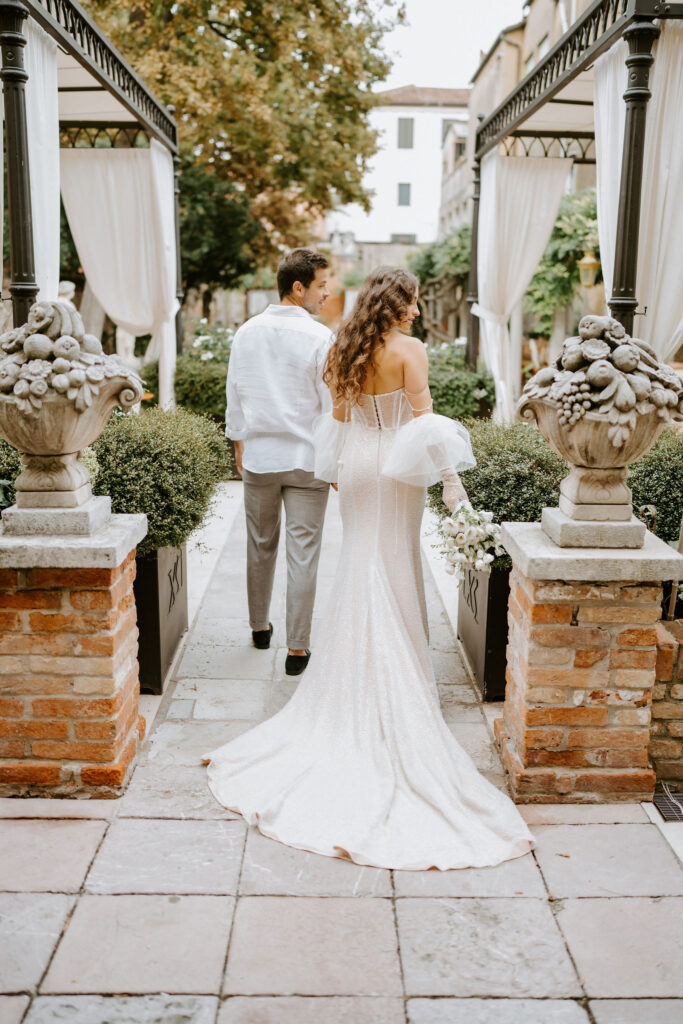 romantic elopement couple walking through a garden area during their venice elopement