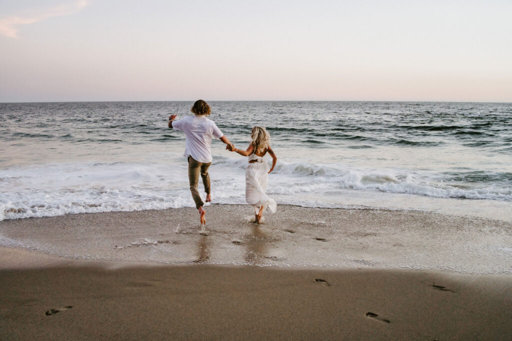 playful bride and groom at the beach during their Laguna Beach elopement in Southern California