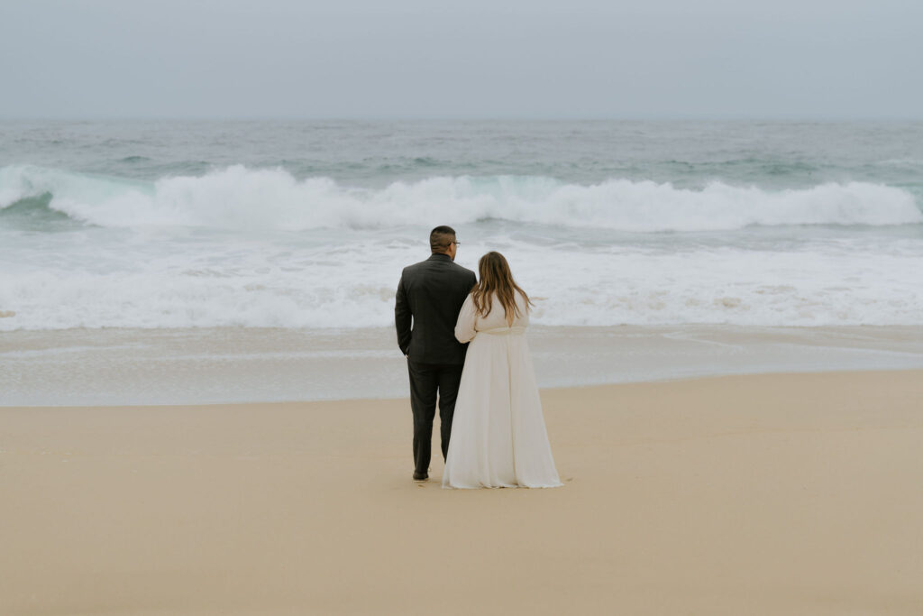 playful bride and groom at the beach during their Big Sur elopement day