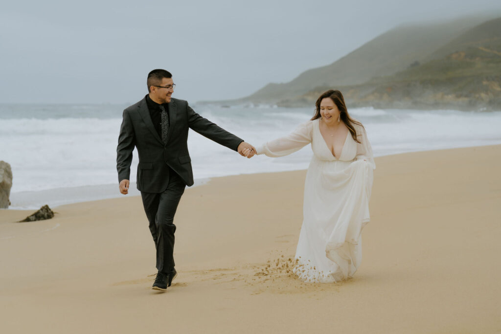 playful bride and groom at the beach during their Big Sur elopement day