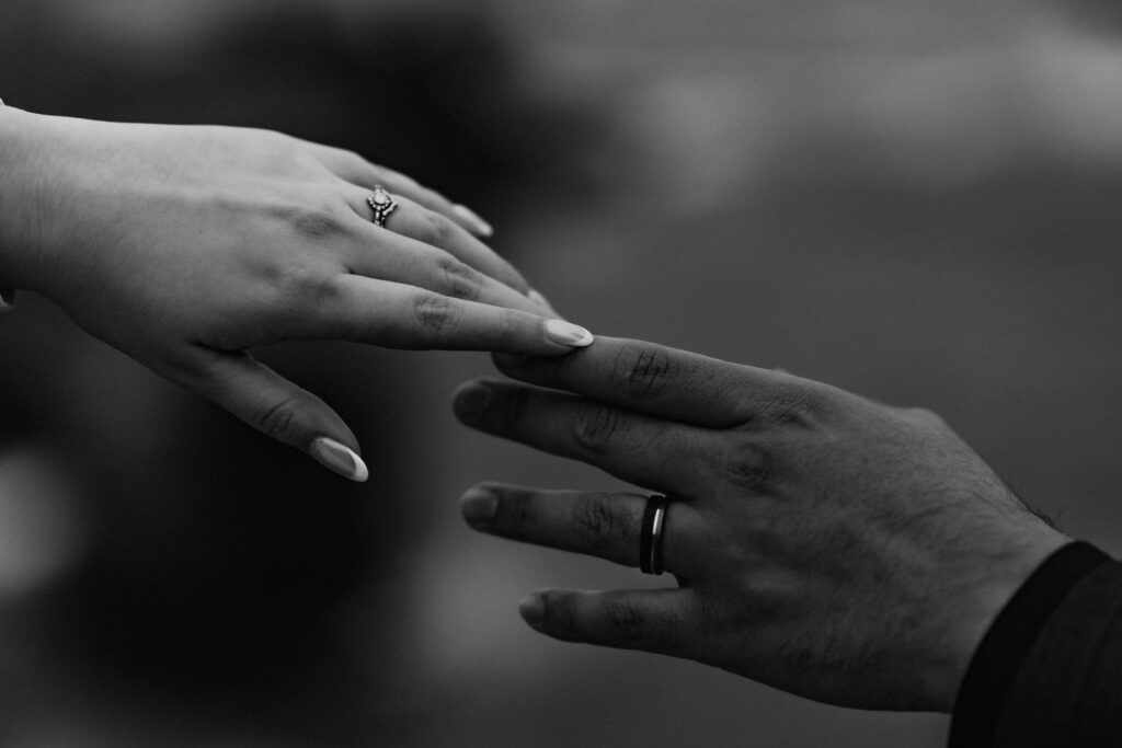 close up of bride and groom reaching towards each other