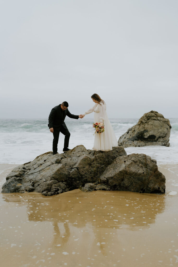 playful bride and groom at the beach during their Big Sur elopement day