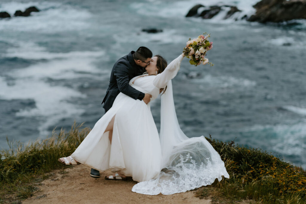 groom dipping his bride for a kiss in big sur