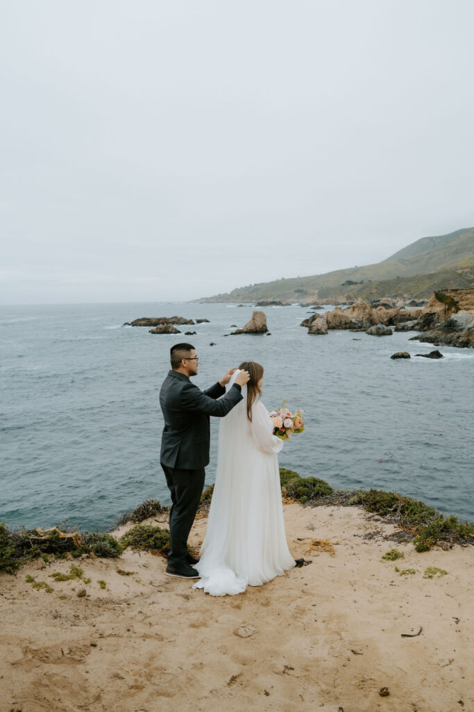 bride and groom on a cliff at Big Sur