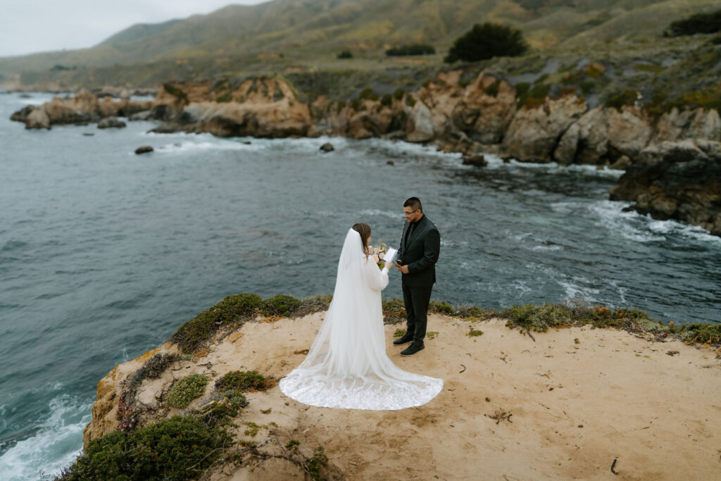 bride and groom private vow exchange on a cliff at Big Sur