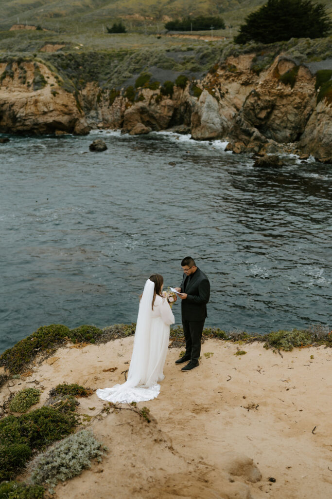 bride and groom private vow exchange on a cliff at Big Sur
