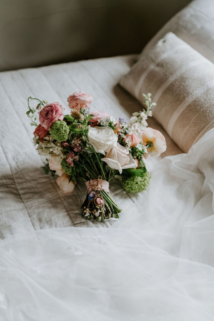 elopement bouquet laid on the bed