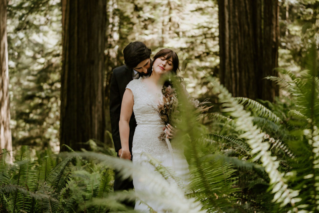 intimate bride and groom hugging moment in the California redwoods
