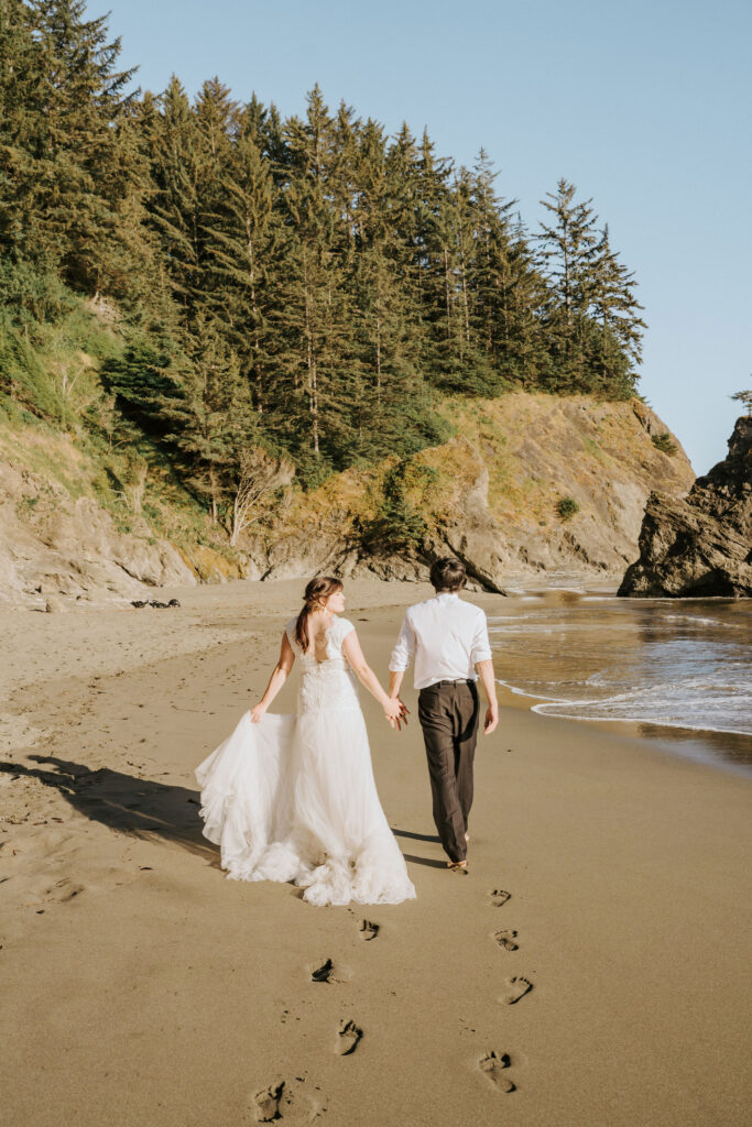 romantic bride and groom walking along the shore during their California beach elopement