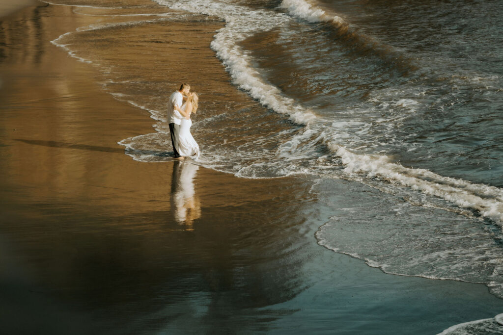 California beach elopement couple standing at the shore