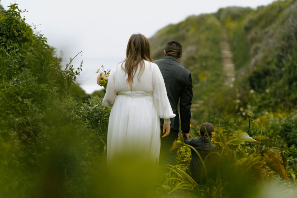 bride and groom exploring Calla Lily Valley during their Big Sur elopement day