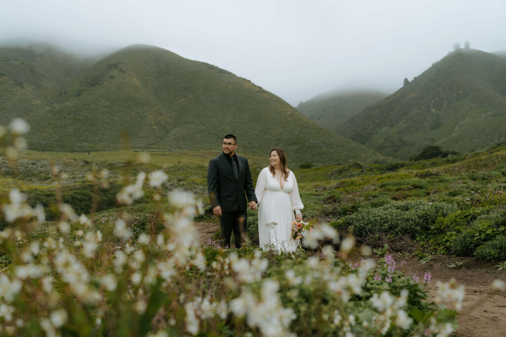bride and groom exploring Calla Lily Valley during their Big Sur elopement day