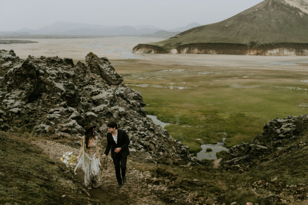 Elopement couple embracing on a moody, rocky hillside in the Iceland Highlands