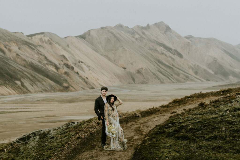 Elopement couple embracing on a moody, rocky hillside in the Iceland Highlands