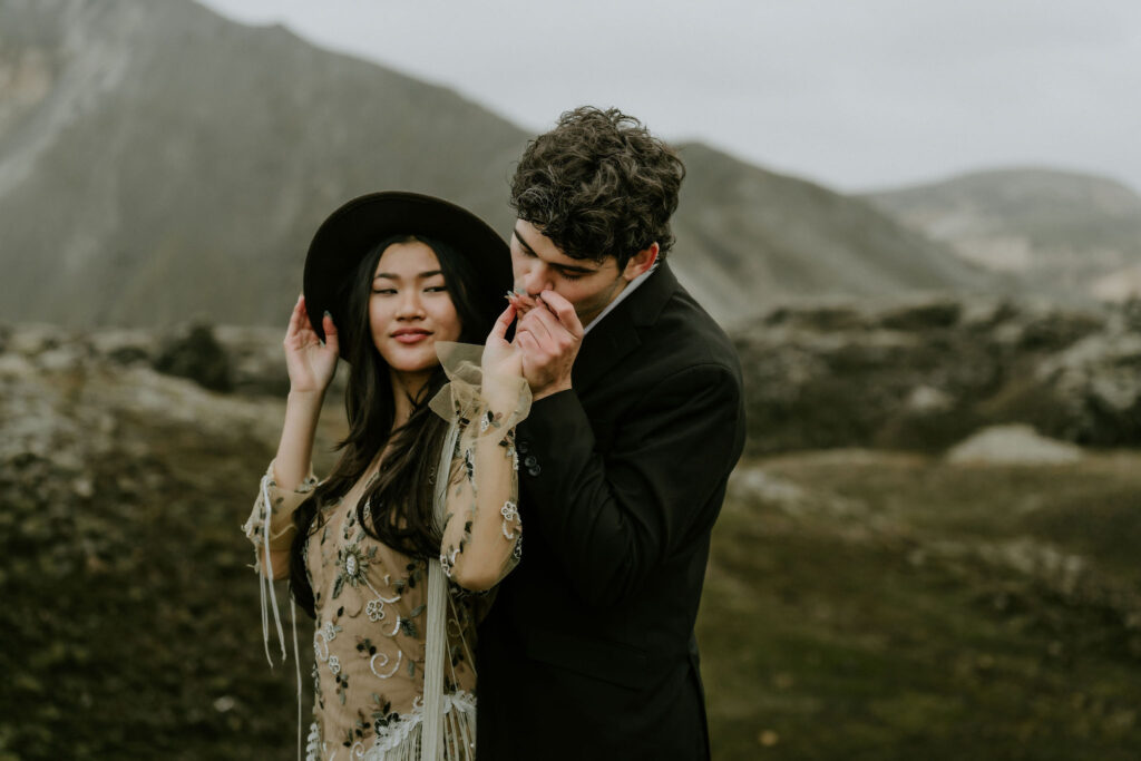 Elopement couple embracing on a moody, rocky hillside in the Iceland Highlands