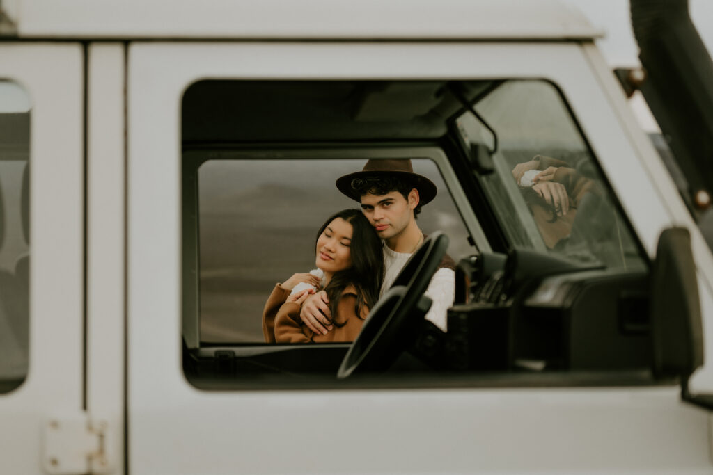 sweet couple posing next to the jeep during their highlands elopement in iceland