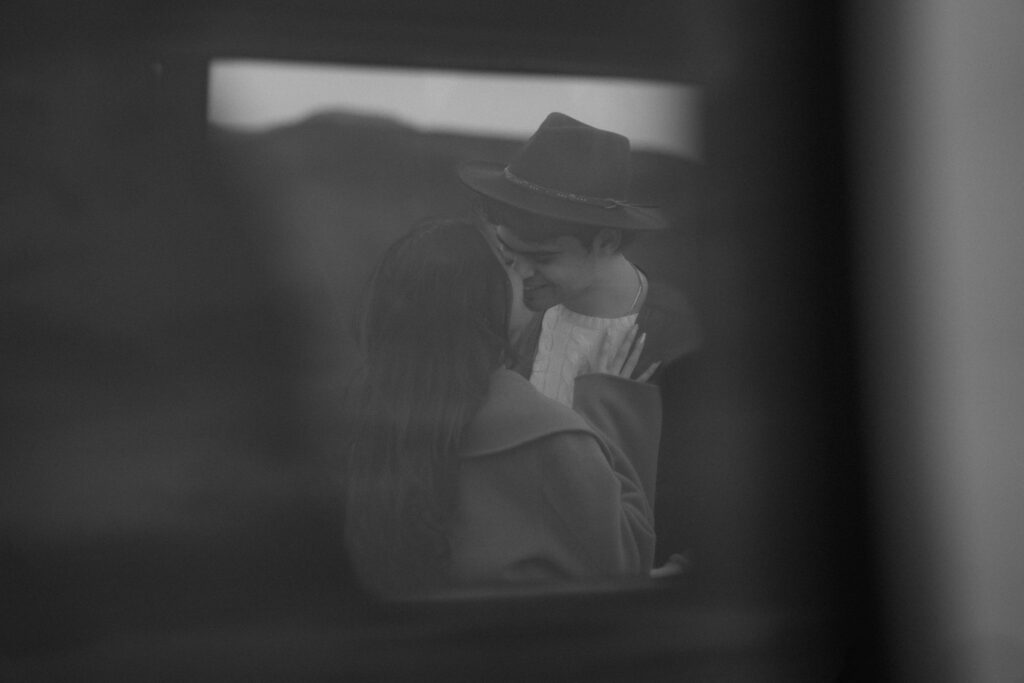 couple captured through a car window