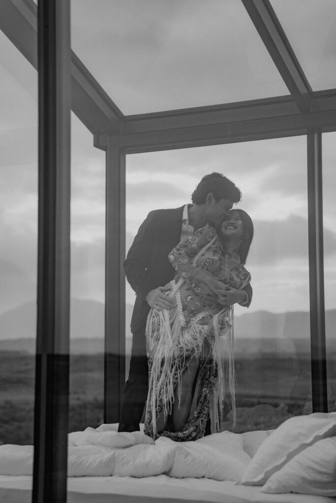 elopement couple inside a glass lodge in iceland