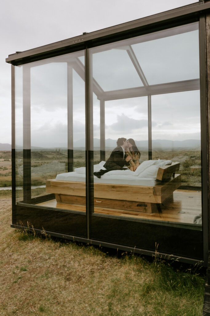 elopement couple inside a glass lodge in iceland