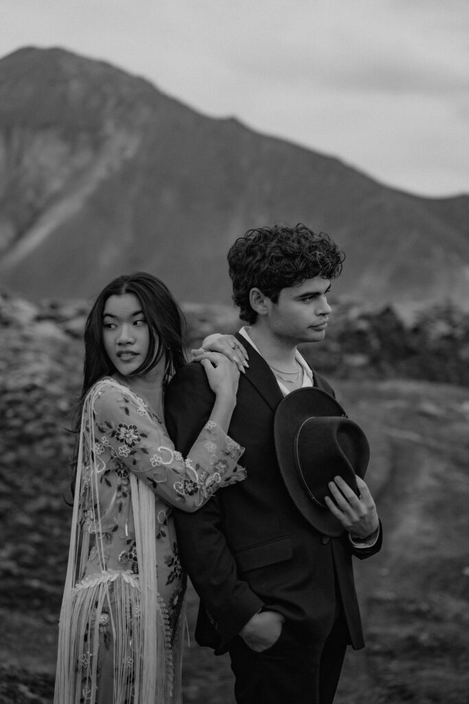 Elopement couple embracing on a moody, rocky hillside in the Iceland Highlands