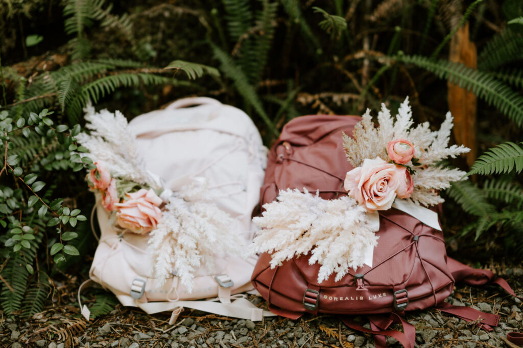 elopement backpacks with boho flowers attached to them