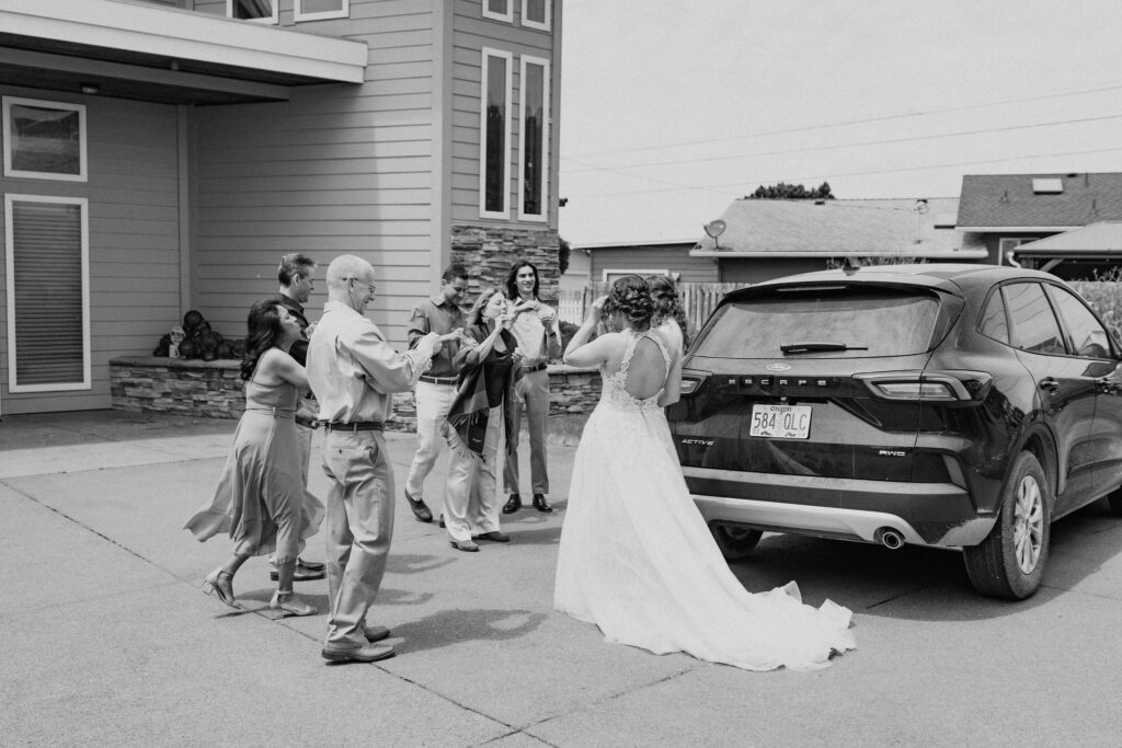 excited family celebrating with the beautiful elopement couple 