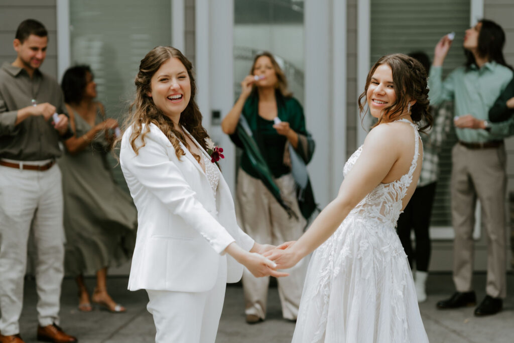 excited family celebrating with the beautiful elopement couple 