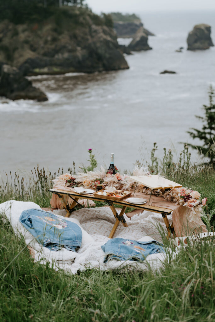 romantic elopement picnic set up at secret beach, oregon