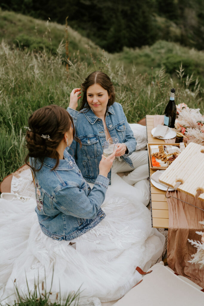 brides enjoying a romantic elopement picnic at secret beach, oregon