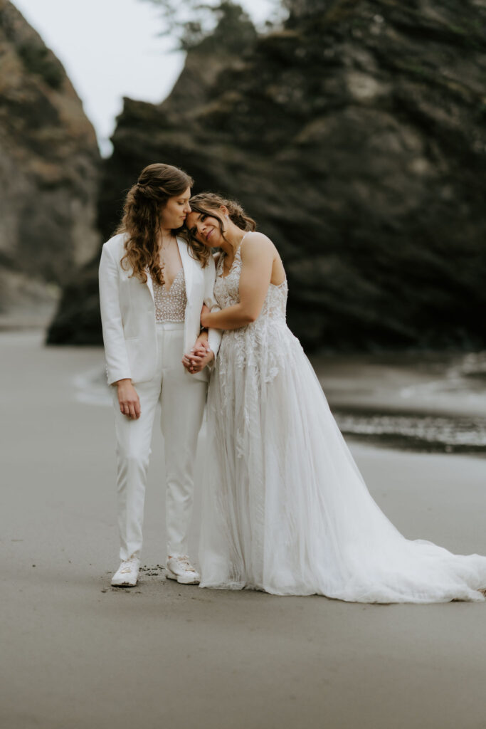 romantic elopement couple hugging at secret beach, oregon coast