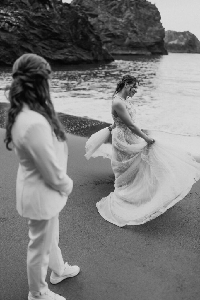 brides walking hand in hand around oregon coast at secret beach