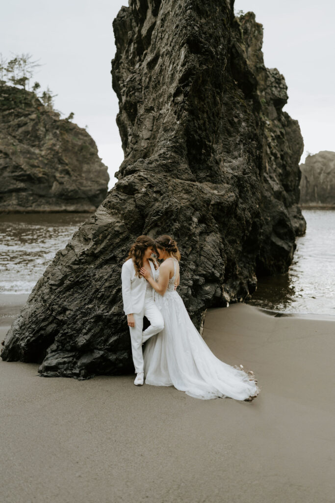 romantic elopement couple hugging at secret beach, oregon coast
