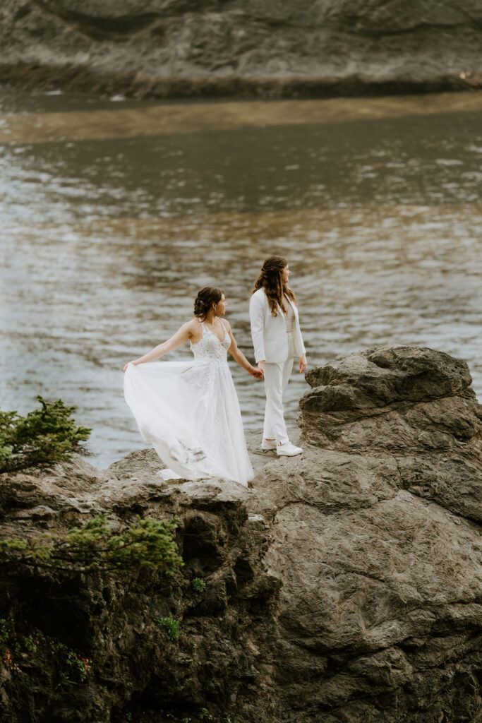romantic moment of brides on a cliff at oregon coast