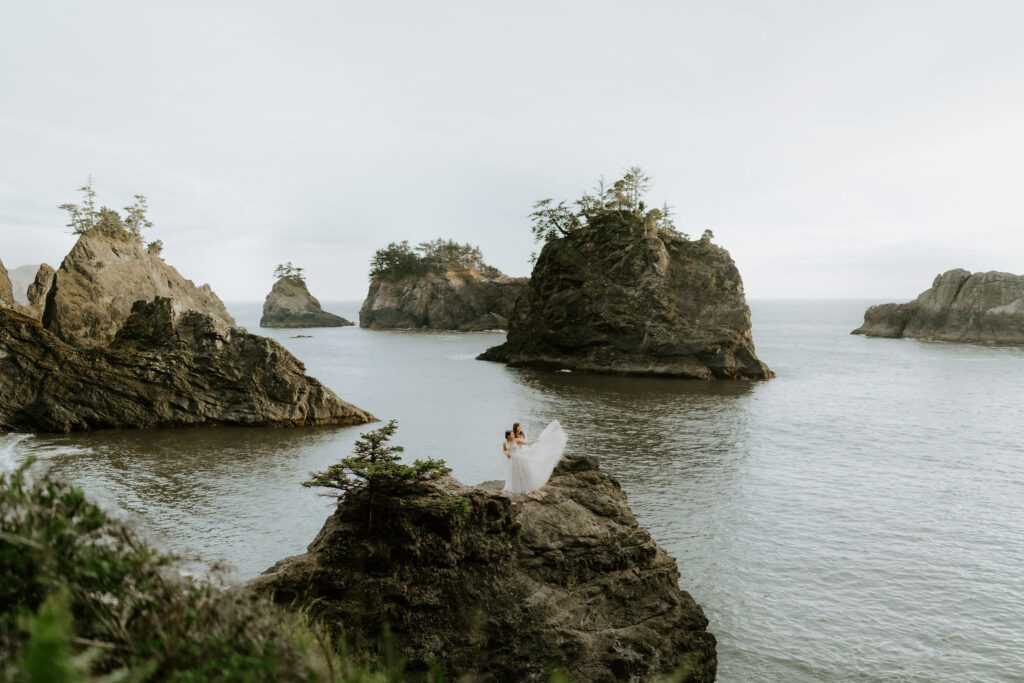 romantic moment of brides on a cliff at oregon coast
