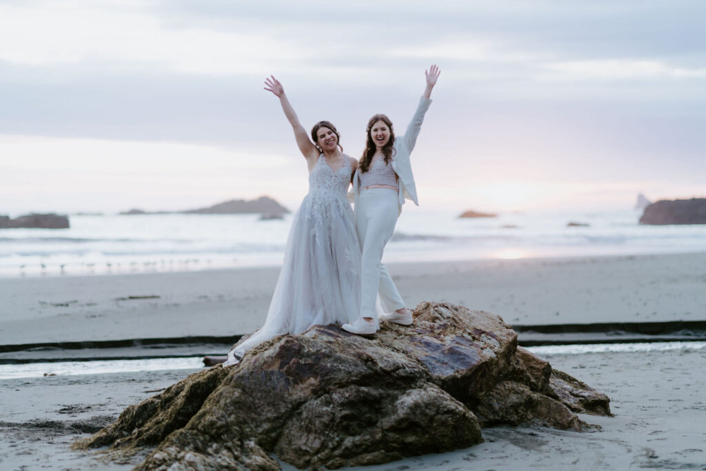 happy elopement couple cheering at oregon coast
