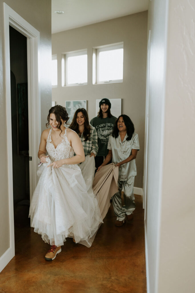 family leading bride to the first look