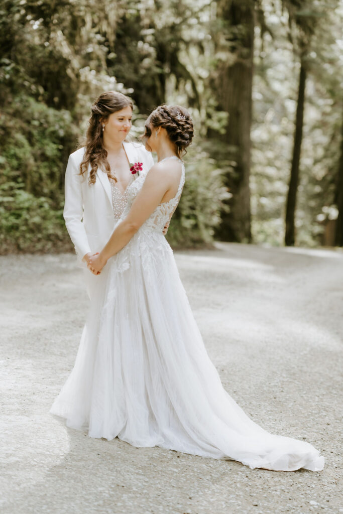 brides dancing surrounded by lush trees during their redwoods elopement in Jedediah Smith State Park