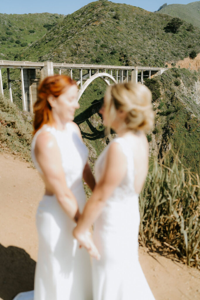 brides exploring the bixby bridge area during their big sur elopement day