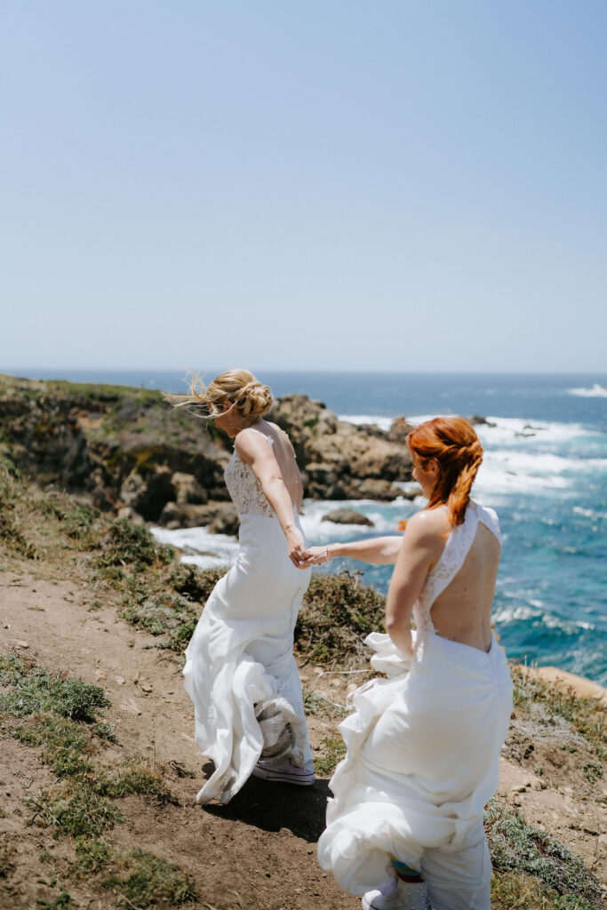 brides roaming around the cliffside in big sur with majestic ocean views