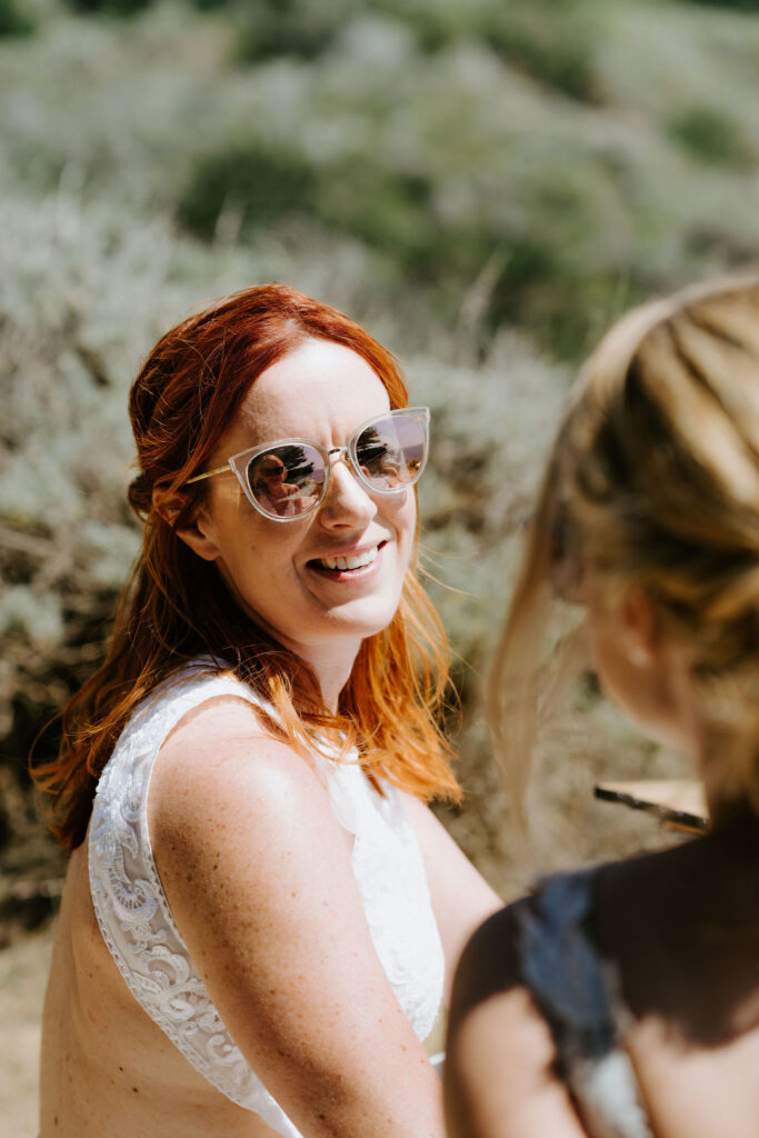 brides enjoying a luxury elopement picnic in big sur overlooking the ocean