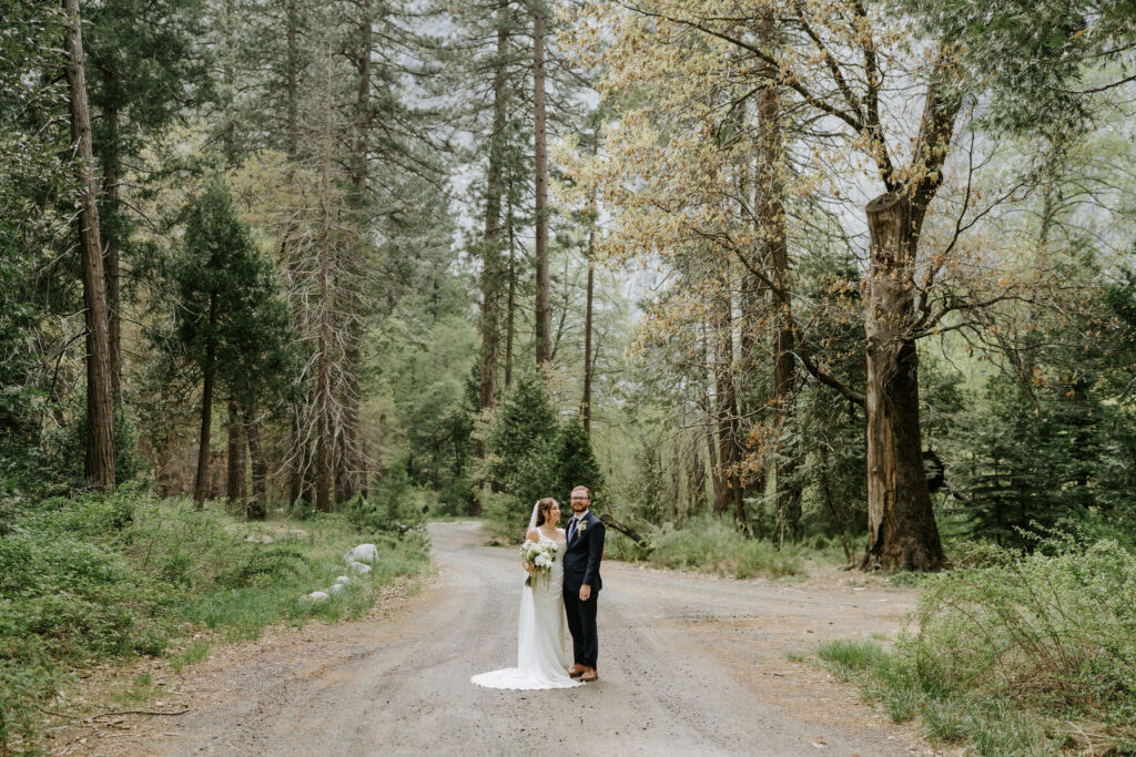 bride and groom surrounded by a forest in yosemite