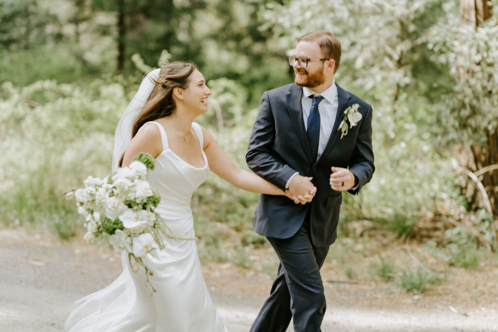 bride and groom running through yosemite national park
