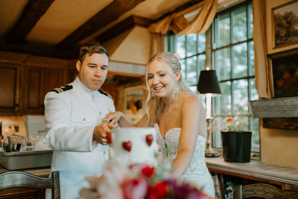 bride and groom cutting cake with a sword