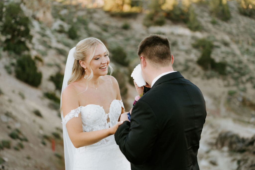 bride and groom exchanging private vows next to a gorgeous lake